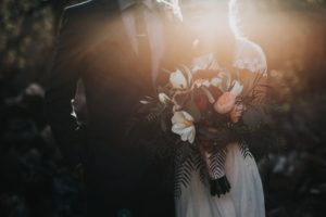 Bride and groom holding bouqet.