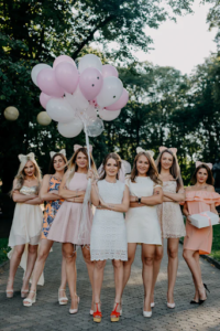 Bridesmaids holding balloons.